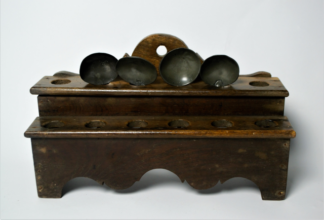 18th century spoon rack with pewter spoons.