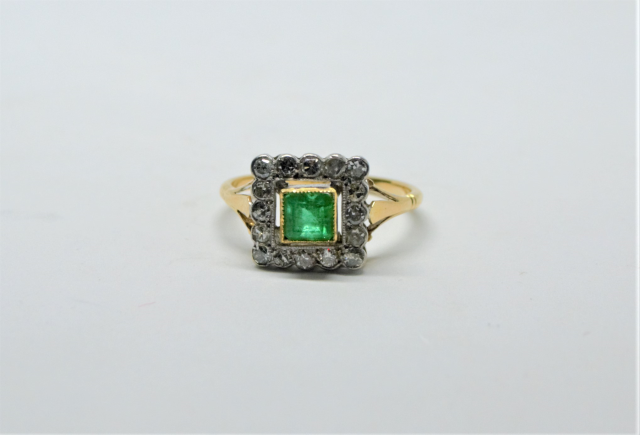 An 18ct Gold Emerald and Diamond Cluster Ring.
