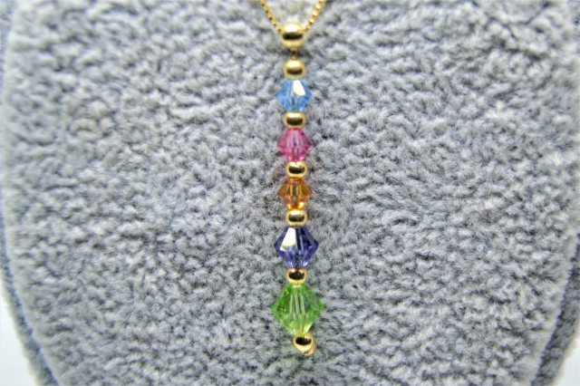 A 9ct Gold Chain with Untested Gem Stones Pendant.