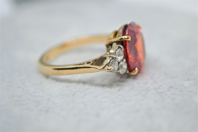 A 9ct Yellow  Gold And synthetic Orange spinel and White Sapphire Dress Ring. 