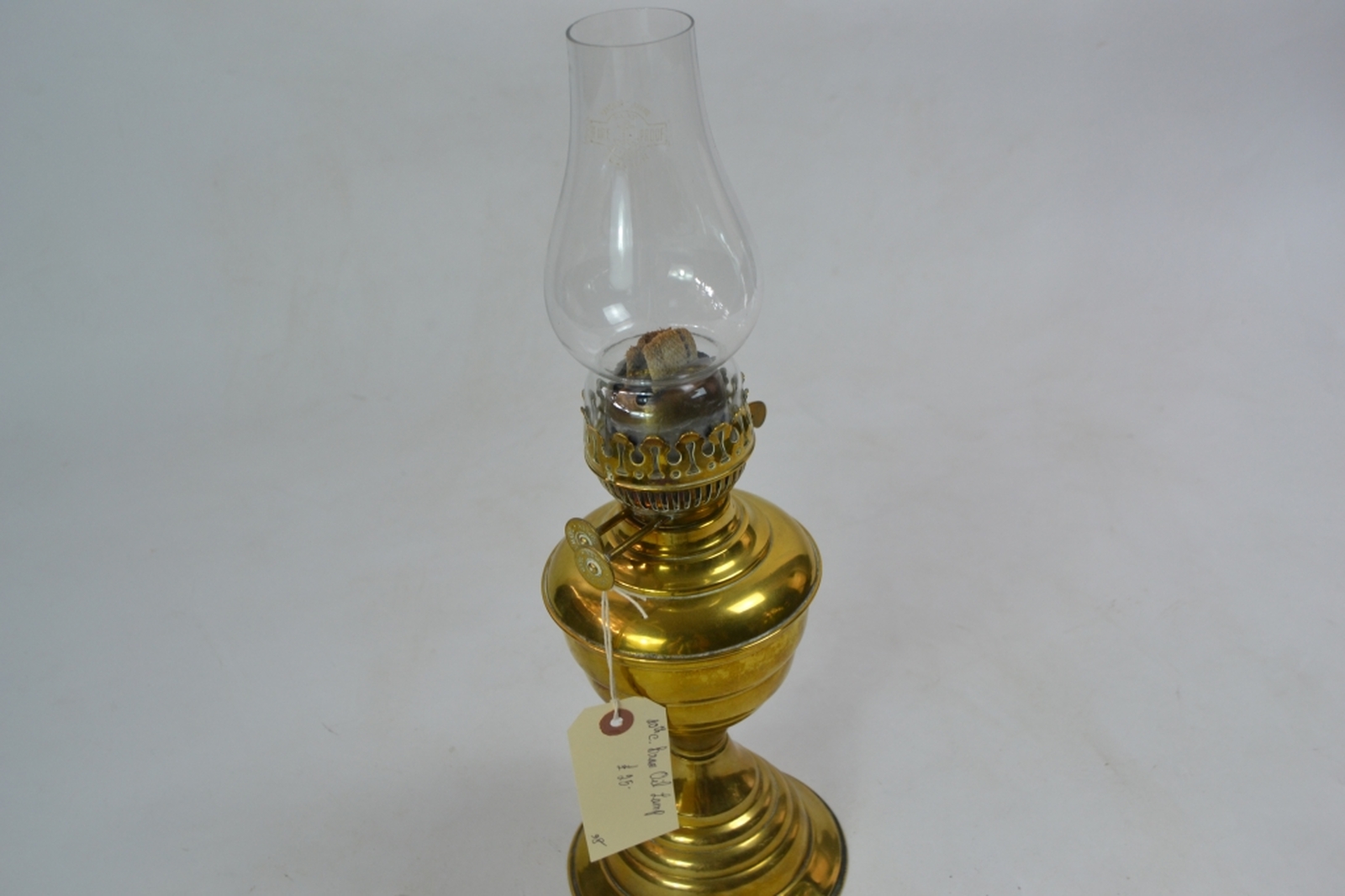 Brass oil lamp early 20th century of lobed baluster form with a typical plain glass chimney