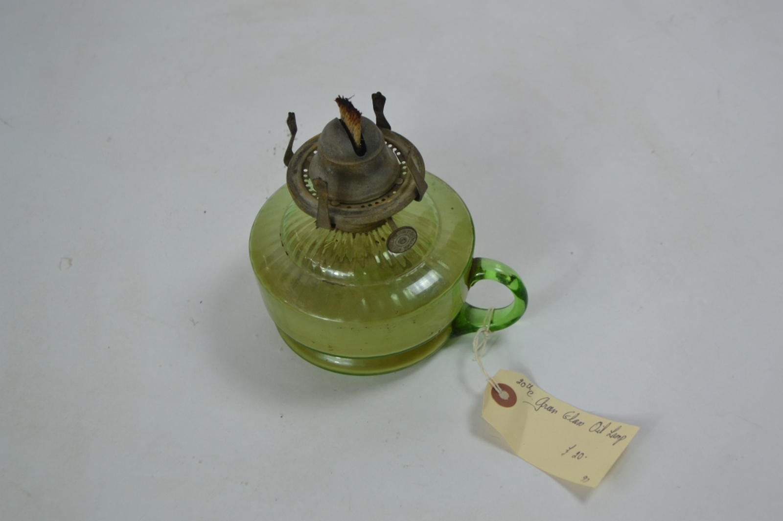 Early 20th century oil lamp with Incandescent green reservoir