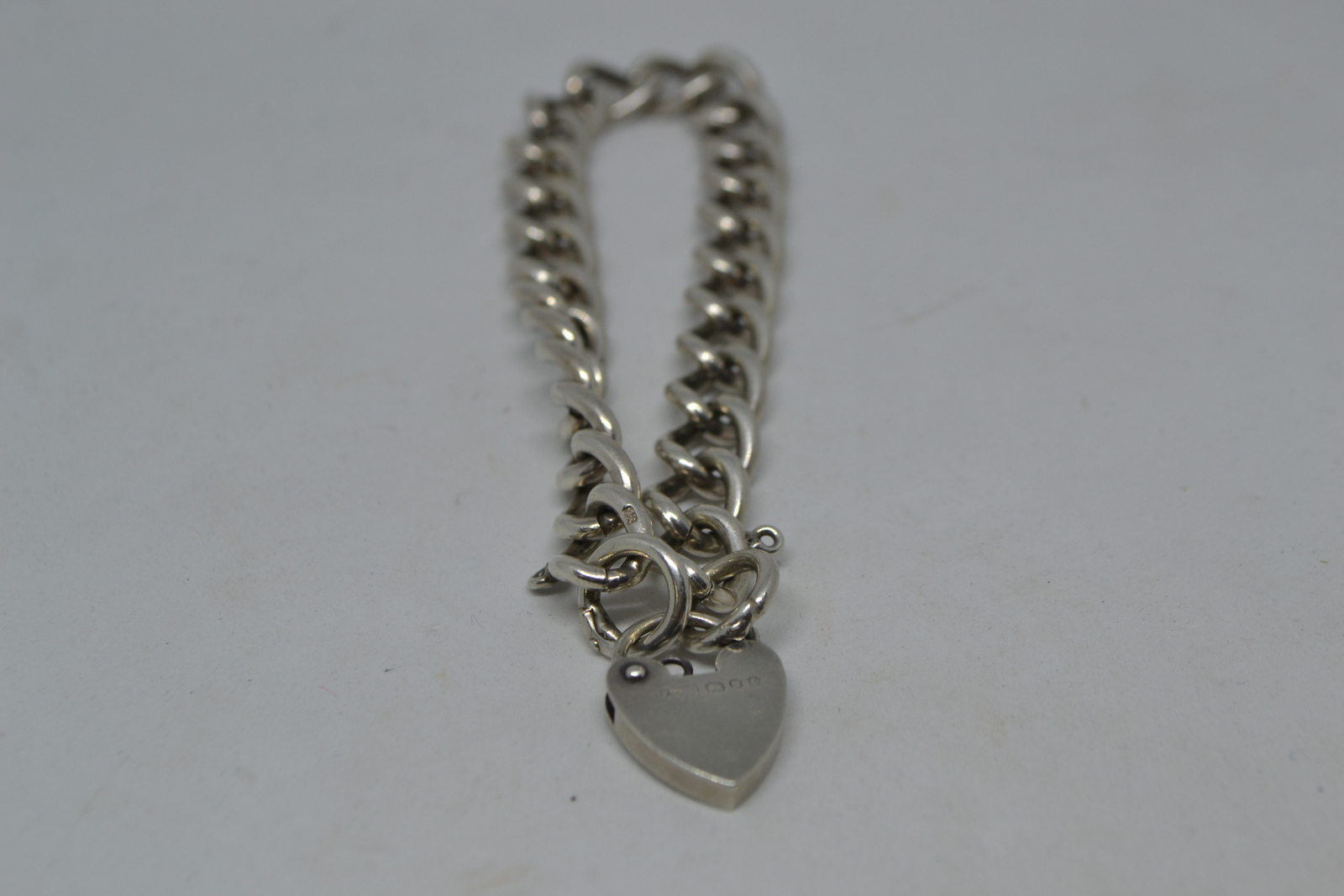 A Solid Sterling Silver Curb Link Bracelet  With Heart Padlock