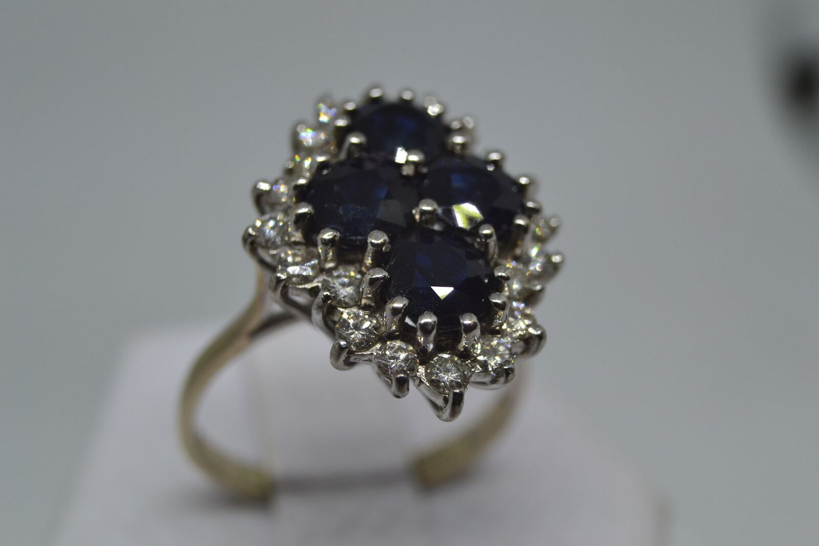 An 18ct white gold sapphire and diamond cluster ring